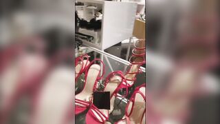 Stylish girlfriends rubbing their pussies in a fitting room while shopping
